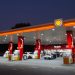 Shell V-Power gas station at dusk with cars at the pumps